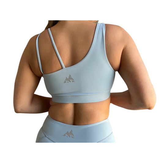 Dusty blue asymmetrical sports bra with one thick strap and two thinner straps