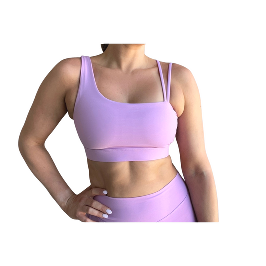 Lavender asymmetrical sports bra with one thick strap and two thinner straps