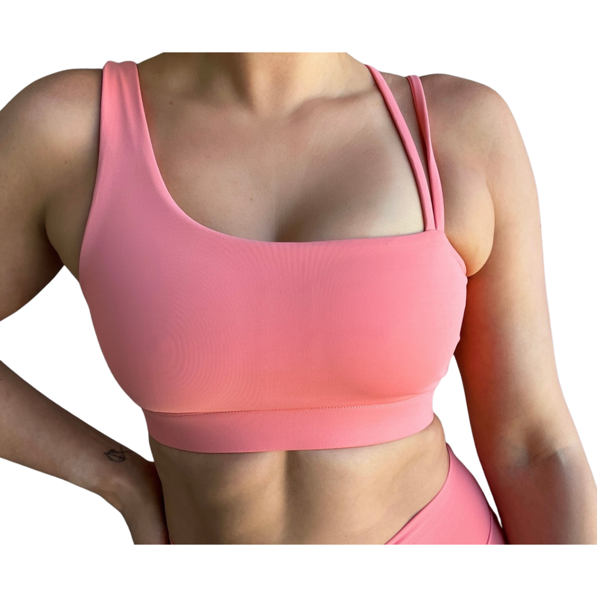 Coral asymmetrical sports bra with one thick strap and two thinner straps